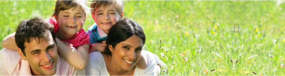 family smiling in the garden