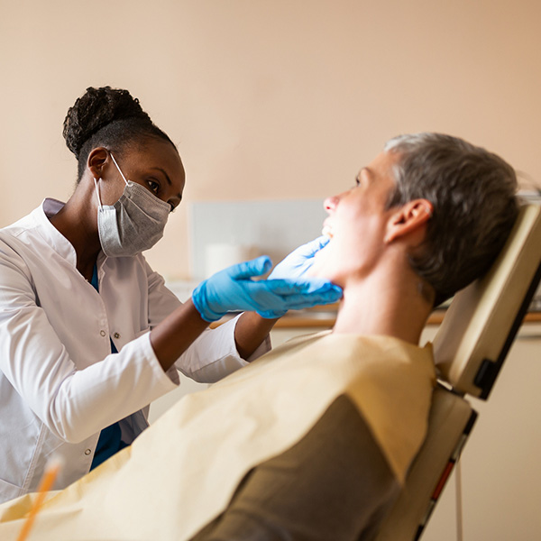 dentist looking at patients teeth