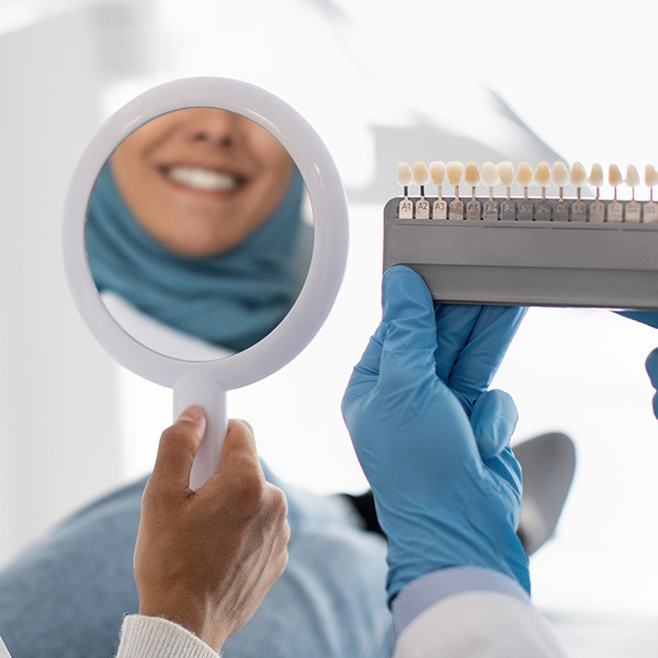 someone looking at and holding veneer samples