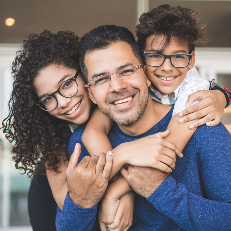 family with glasses on smiling