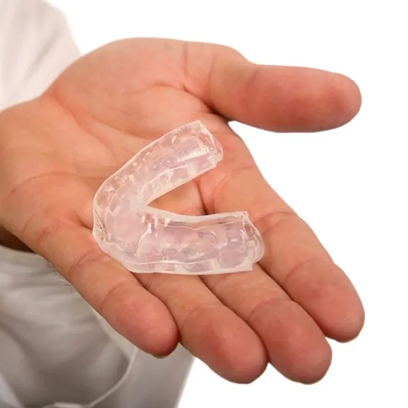 someone holding a mouth guard