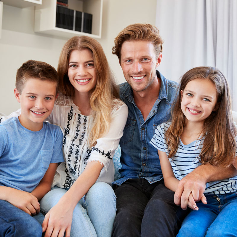 family on couch smiling